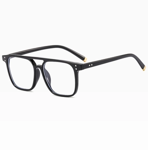 Detail view of retro double-bridge black square frames with decorative gold accents