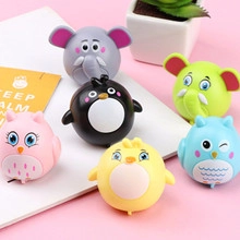Flat lay of colorful cartoon animal pull-back cars featuring owls, elephants and penguins