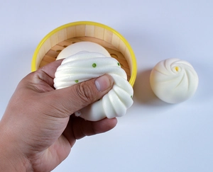 Primo piano di una mano che preme un panino finto realistico con mini vaporiera