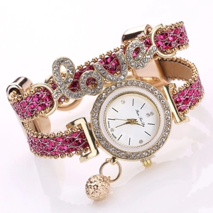 Detail of Fan Tee Da watch with LOVE letters, pink glitter texture, and rhinestones
