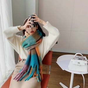 Close-up of soft rainbow plaid scarf with long fringes shown in natural light