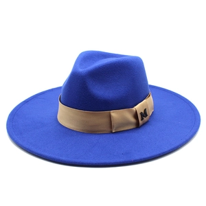 Detail of royal blue wool fedora with champagne band and metallic M buckle logo
