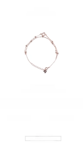 Detailed macro view of S925 silver rose gold bracelet with crystal D charm and heart tag