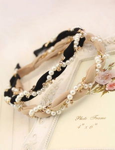 Detail of twisted fabric headband with inlaid pearls and sparkling square rhinestones