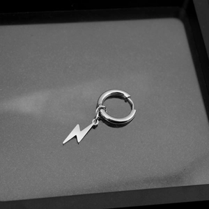 Macro detail of silver lightning bolt earring with polished stainless steel finish