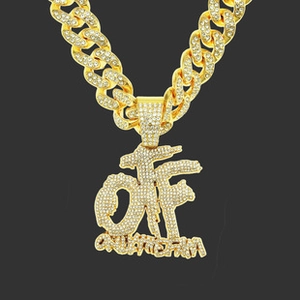 Detail of gold Cuban chain necklace with iced out OF Only The Family pendant