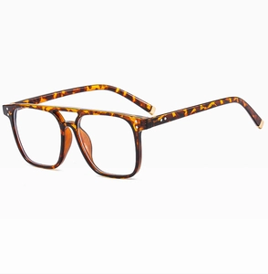 Detail of tortoise shell square frame sunglasses with a double bridge and gold metal tips