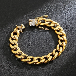 Macro view of gold-plated Cuban chain bracelet with crystal-encrusted dragon buckle
