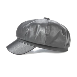 Macro detail of the black leather octagonal baker boy hat showing premium stitched panels