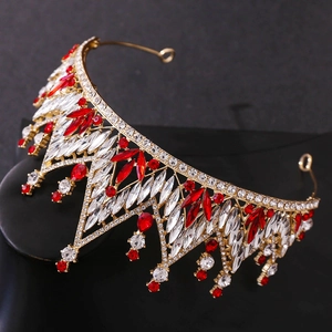 Detailed macro view of golden baroque tiara with sparkling red crystals and gemstones