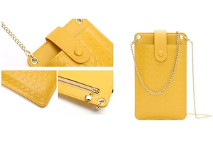 Detail of yellow crossbody phone bag featuring woven texture and gold chain strap
