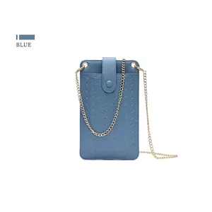 Detailed close-up of blue woven texture phone bag with elegant gold metal chain strap