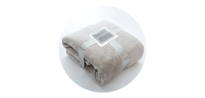 Close-up of soft grey flannel blanket folded with a silver ribbon gift packaging