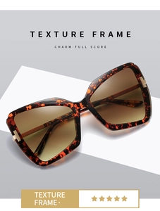 Detail of tortoiseshell texture frame with golden T-metal hinge and gradient lens