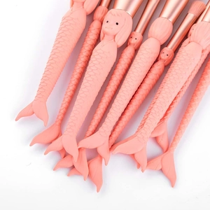 Set of 10 mermaid makeup brushes with pink sculpted handles and rose gold ferrule detail
