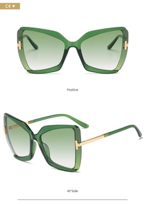 Detail of butterfly frame sunglasses with gradient green lenses and golden T-hinge detail