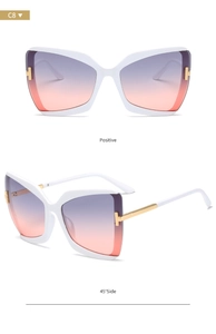 Detail of white butterfly sunglasses with gradient lenses and gold T-hinge accents
