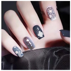 Floral nail stamping kit with dark grey base, clover patterns and glitter accents