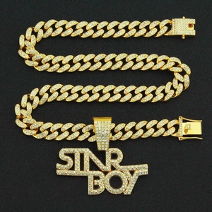 Detail of gold Cuban chain and iced-out letter pendant for hip hop necklace jewelry
