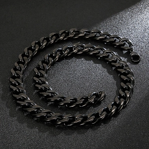 Detailed close-up of heavy black stainless steel Cuban link chain necklace with polished finish