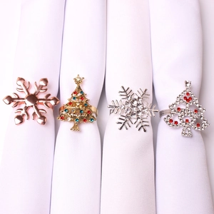 Detail of Christmas napkin rings featuring snowflake and rhinestone tree designs