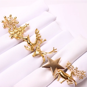 Set of 6 gold metal Christmas napkin rings featuring snowflake and reindeer designs