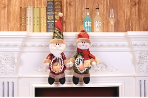 Detail of Santa and Snowman leather candy bags on fireplace mantel with Christmas decor