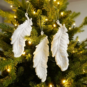 Sparkling white feather Christmas tree ornaments with silver glitter and warm light