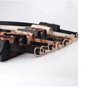 Close-up of various animal print mini belt bags with gold chain details and textures