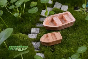 Macro view of two resin assault boat miniature models on moss with wood grain details