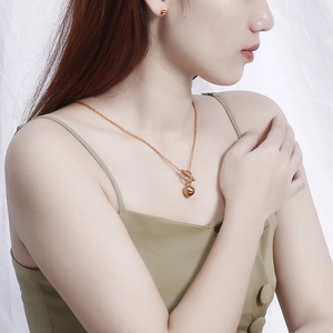 Elegant gold ball pendant necklace with T-bar clasp and matching stud earrings for women