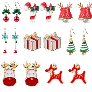 Detailed view of eight pairs of festive Christmas earrings with bells and snowflakes
