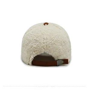 Detail of warm off-white teddy fleece cap featuring brown suede adjustable strap and metal buckle