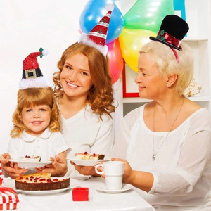 Three women wearing diverse festive Christmas headbands and hats during a holiday party