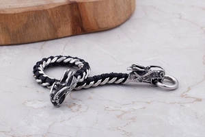 Close-up of double dragon heads on vintage braided leather bracelet for men