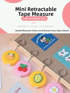 Close-up of mini retractable tape measures with fruit charms and metal keychains
