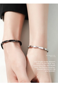 Close-up of Mobius silver couple bracelets with No.52 engraving and woven rope detail