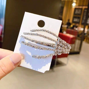 Close-up of skeleton hand hair clip with white rhinestones on a display card