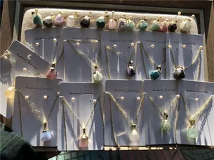 Detailed group view of faceted raw crystal necklaces with gold edges on display cards
