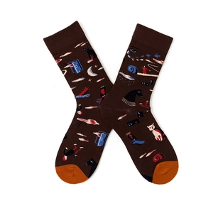 Detail view of artistic pattern socks featuring black cat and eye motifs in vintage brown