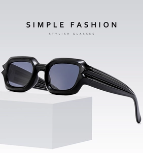 Detail of glossy black punk sunglasses with unique grooved temples on a geometric stand