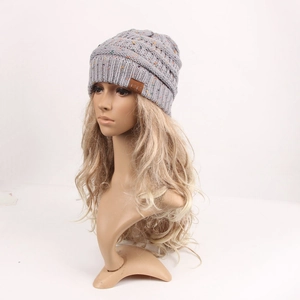 Grey knit winter beanie with colorful specks and a leather C.C brand label on the cuff
