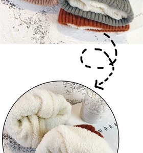 Macro detail of thick sherpa fleece lining inside a warm winter knitted beanie hat