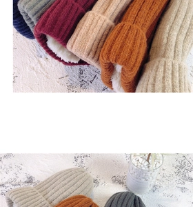 Close-up of thick knit beanie texture with various colors and warm fleece lining