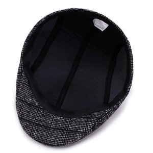 Retro black and white plaid newsboy cap featuring thick tweed fabric and elastic strap