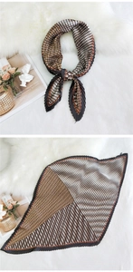 Detailed view of pleated silk scarf with retro geometric patterns and satin texture