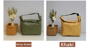 Detail of army green and khaki Tyvek lunch bags with textured finish and black handles