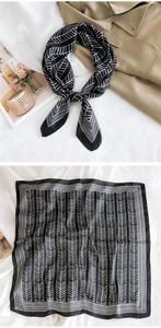 Detail of black and white geometric silk scarf paired with a trench coat for styling