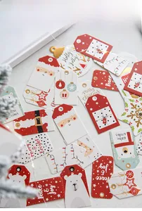 Detailed view of paper Christmas gift tags featuring Santa and polar bear illustrations