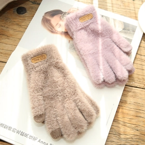 Detailed view of plush knit gloves featuring cartoon bear patches and touchscreen fingertips